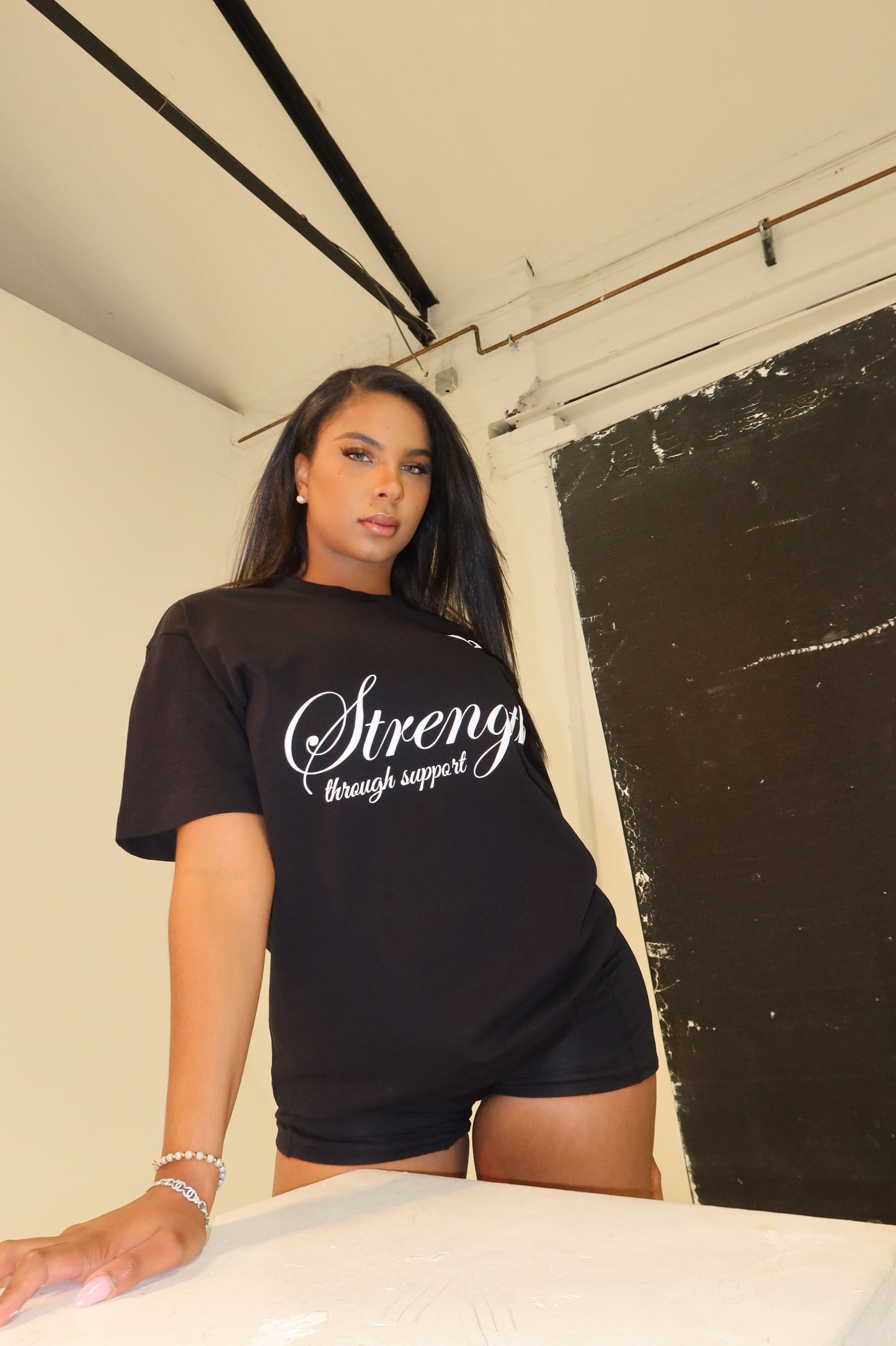 Strength Through Support” T-Shirt – We Hold A Hand Edition
